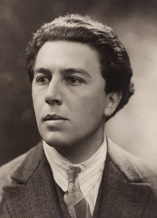 André Breton (photograph by Henri Manuel) — he wrote the definition before the method had a name, then spent a decade keeping the method honest.